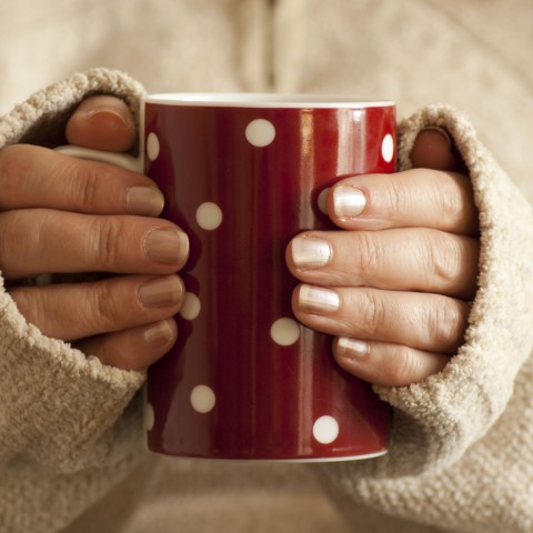 Woman olding Red Polkadot Coffee Mug