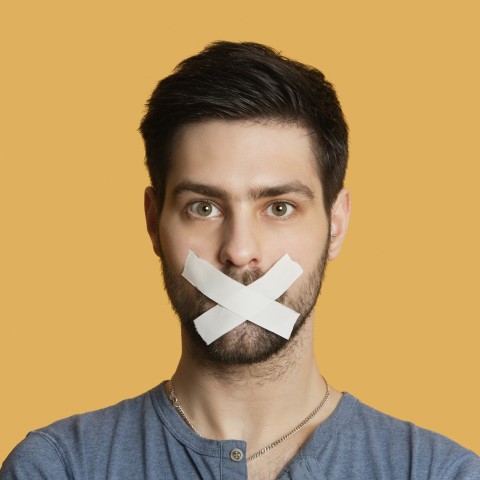 A Man with Tape Over His Mouth