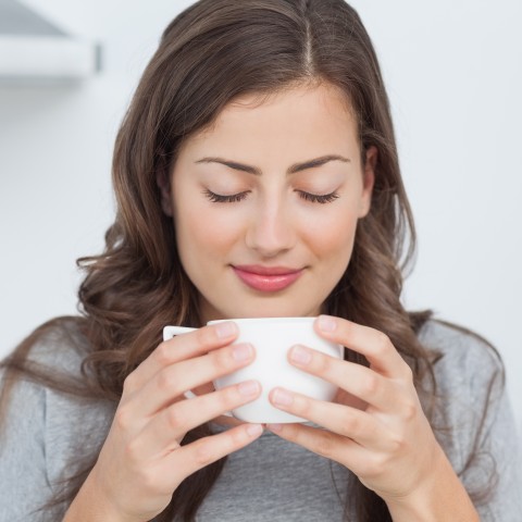 Woman Smelling Coffee