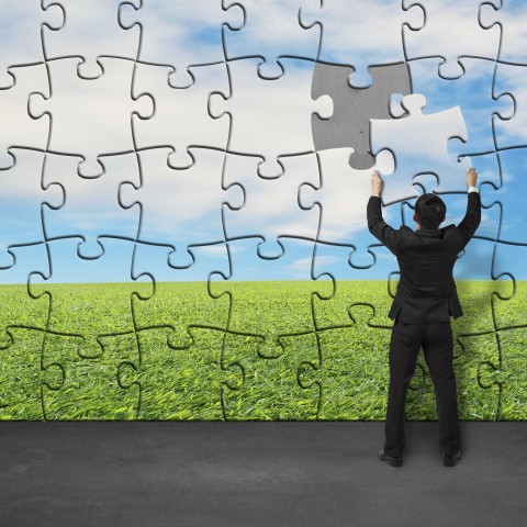 A Man Arranging a Big Puzzle