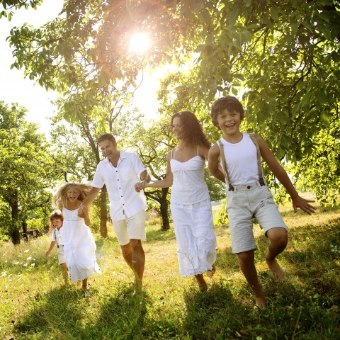 Family Running through Park Together