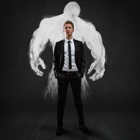 Guy in Suit in Front of a Muscled Shadow