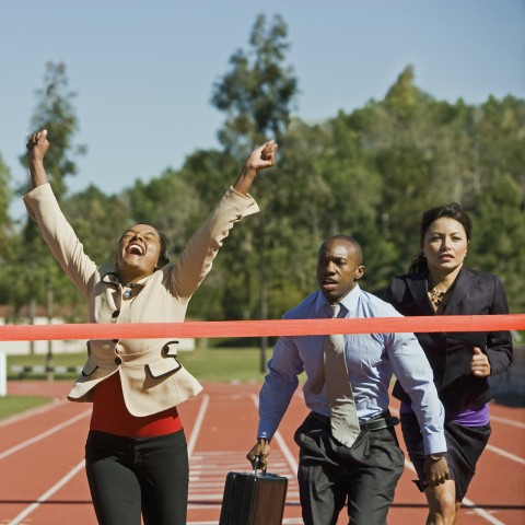 Three Business People Running to a Finish Line