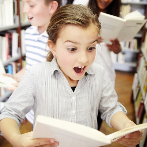 A Little Girl Amazed at a Book She’s Reading