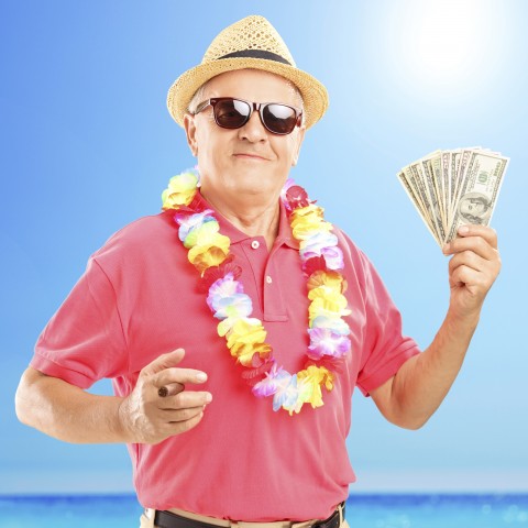 An Old Guy Fanning Out His Money while Holding a Cigar