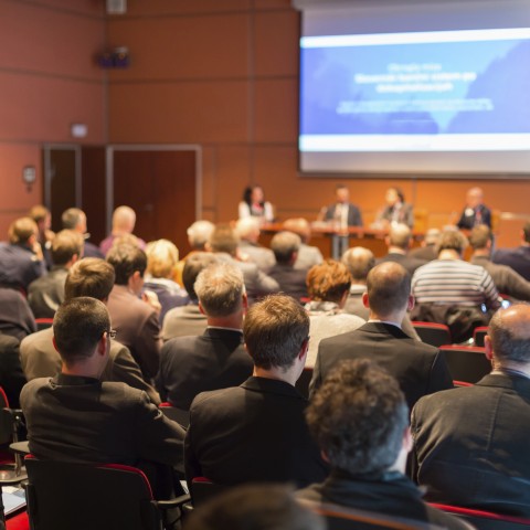 A Group Giving a Speech in Front of an Audience