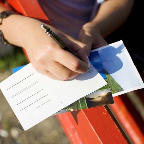 A Woman Writing on the Postcard