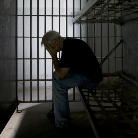 Man in Cell Expressing Deep Sorrow