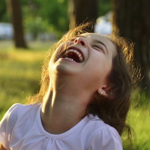 A Young Child Laughing with Abandon.