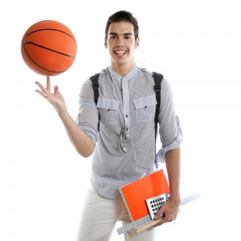 A Guy in a Gray Shirt Smiling with a Basketball