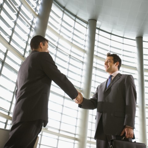 Two office workers shaking hands