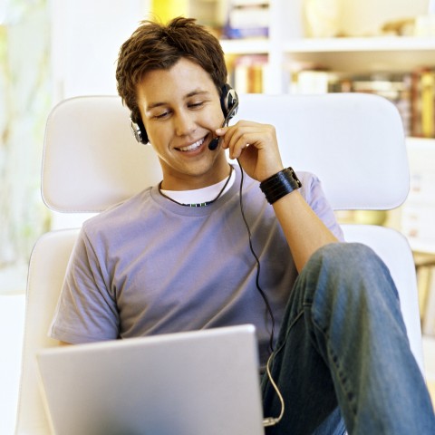 a young man practicing his pronunciation with a microphone headset