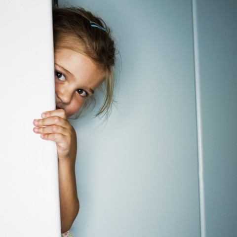 Girl Hiding Behind Door