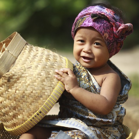 A Little Toddler Holding a Straw Basket