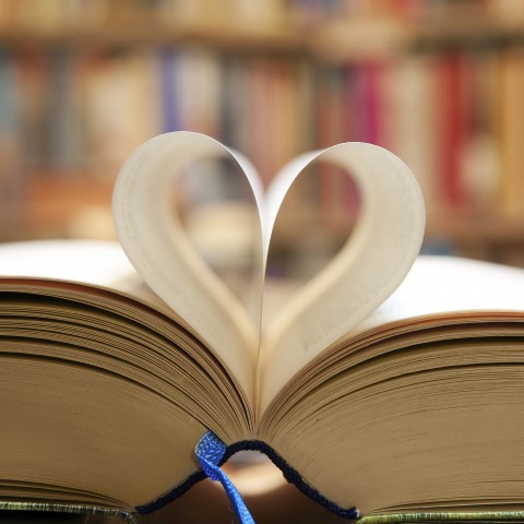 A Book Open to the Middle, with Two Pages Folded to Make a Heart Shape