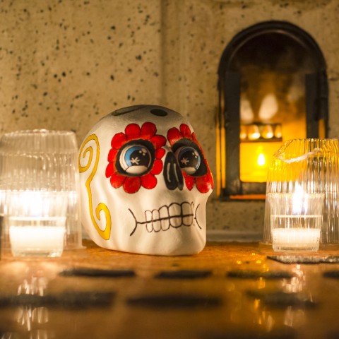 A decorated fake skull and candles
