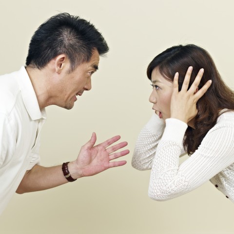 Asian Couple Fighting Head-to-Head, Woman Blocking Her Ears