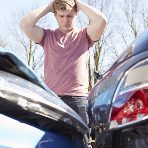 Distraught Man Looking at Car