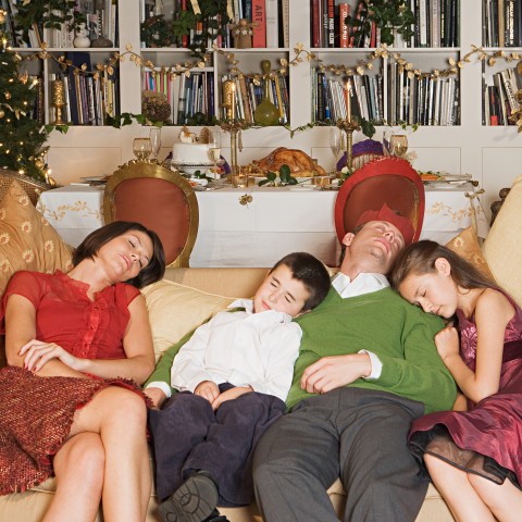 A Family Asleep on the Couch After Thanksgiving Dinner