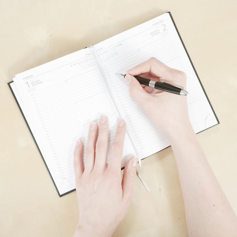 Woman Writing Something in a Journal