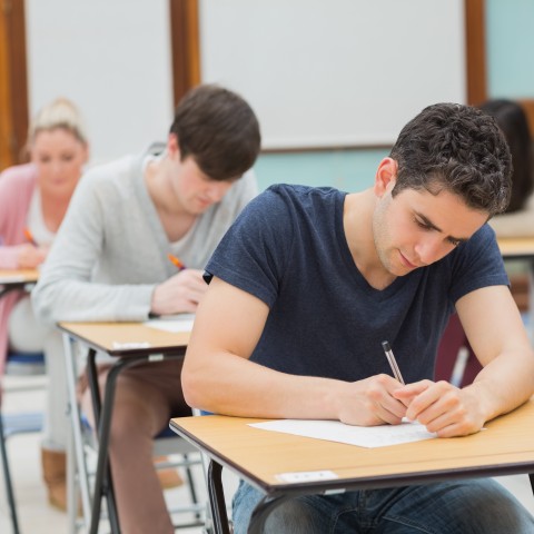 People Taking a Test in a University Classroom