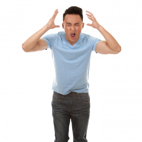 Asian Man Yelling, Bent Forward, with His Hands Held Up Next to His Head