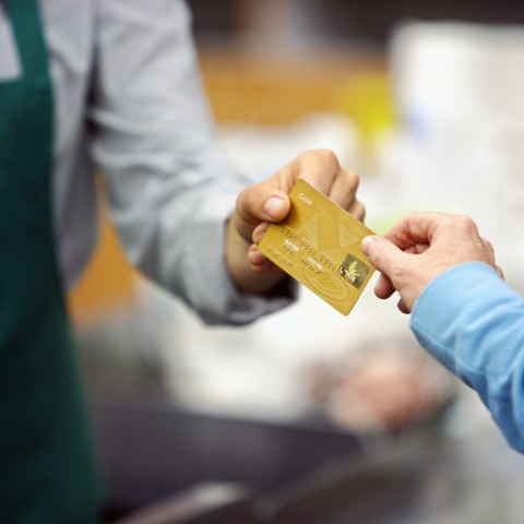 Man Handing Credit Card to Clerk