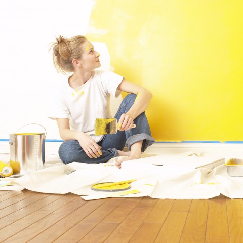 A Woman Painting the Walls of Her New Apartment Yellow