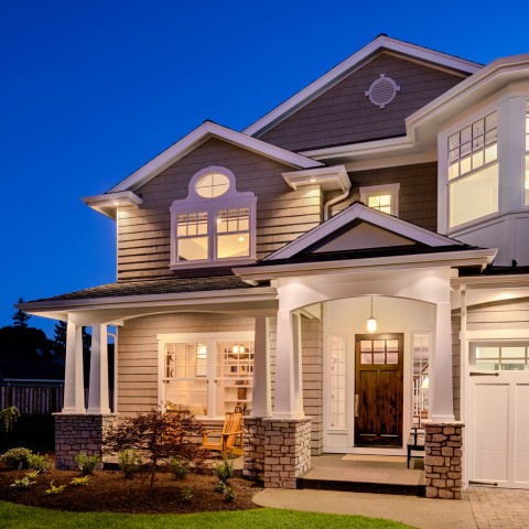 Large, Double-Story House with Lit Windows.