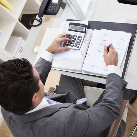 Man Calculating Numbers at Work