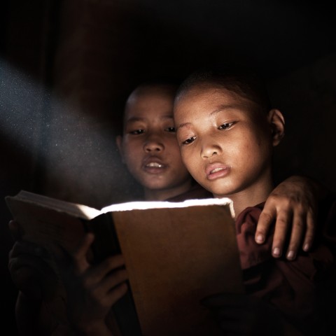 Two Kids Reading in the Dark