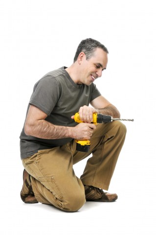 A Man Holding a Drill