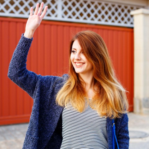 A Woman Waving Goodbye to Someone