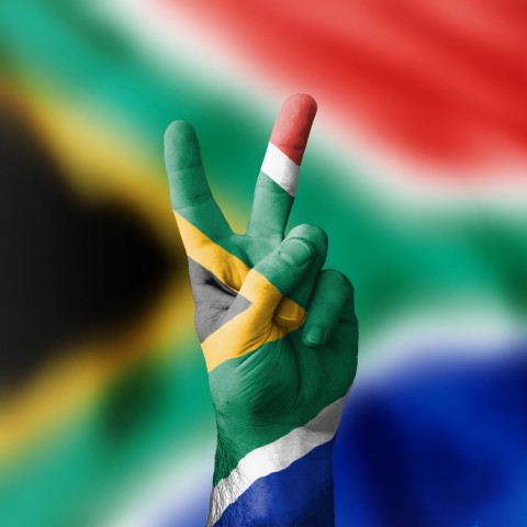 A Hand Painted in the Colors of the South African Flag Showing the Universal, 2-finger Peace-sign.