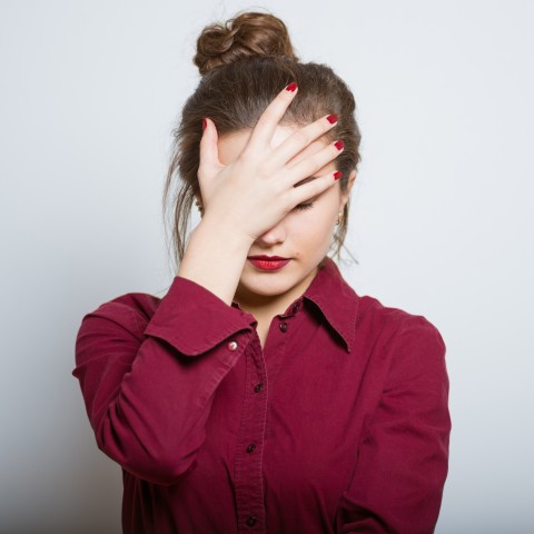 Stressed Woman Holding Her Head with Her Hand