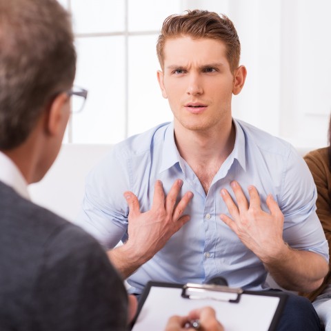 Frustrated Man Pointing to Himself with Both Hands