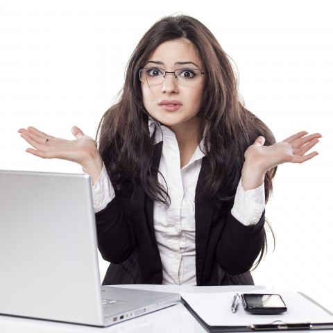 A Businesswoman at Her Computer, Shrugging