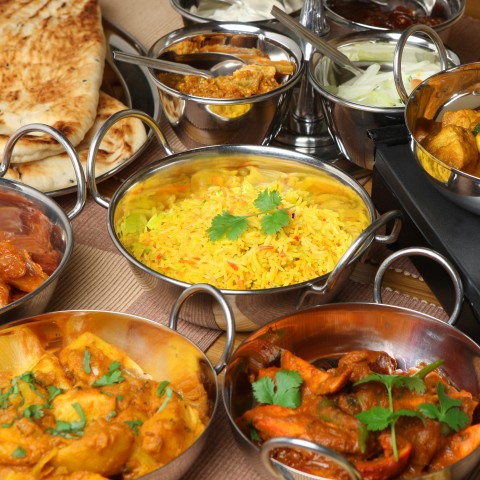 Lots of Food on a Table in Aluminium Pots, Rice, Chicken Wings, Etc.