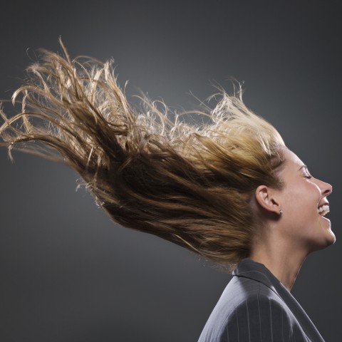 Laughing Woman with Closed Eyes and Hair Blown by the Wnd