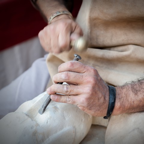 A Man Chiseling to Make a Sculpture