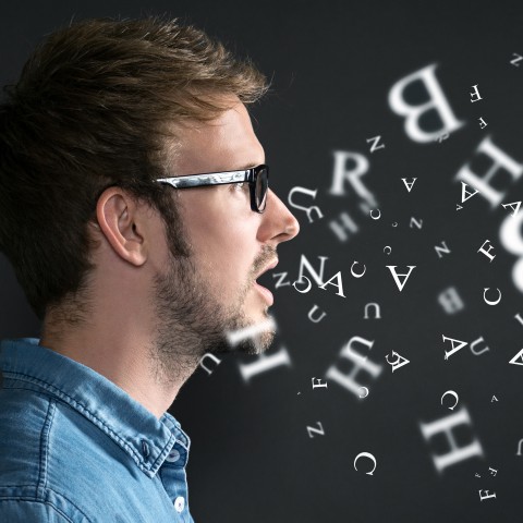 Man practicing his pronunciation of verbs