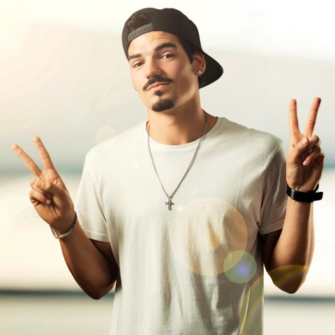 Young Rapper Showing the Victory Sign (also Called Peace Sign) with Both Hands