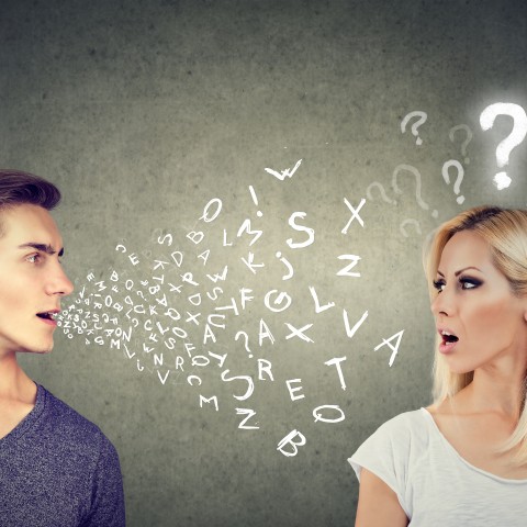 Man Speaking to Woman with Letters and Question Mark Floating