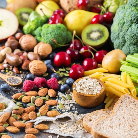 Assortment of Healthy Food Items Such as Fruit, Nuts, Oats, Vegetables, etc.