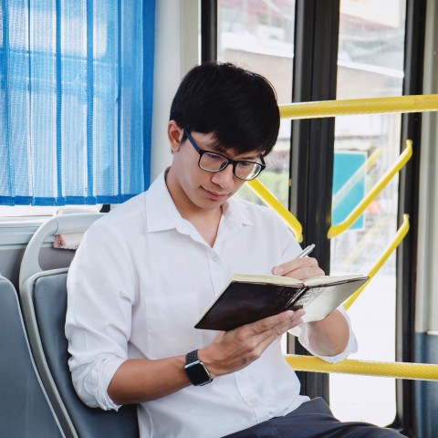 Man Reading a Book on the Train