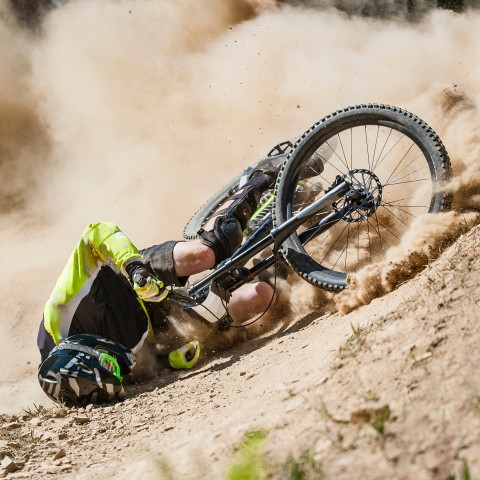 A Motor Biker Falling Onto the Sand