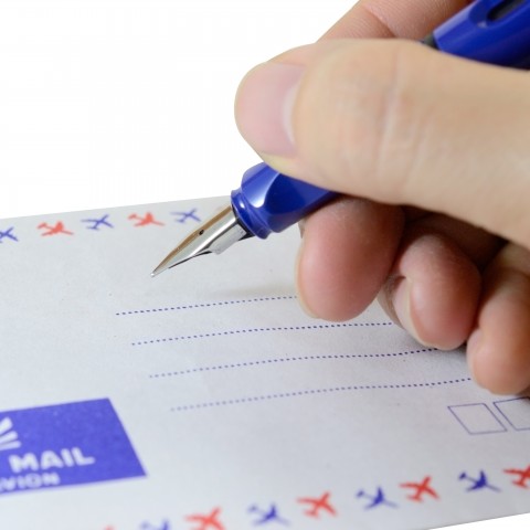 A Person about to Write an Address on an Envelope