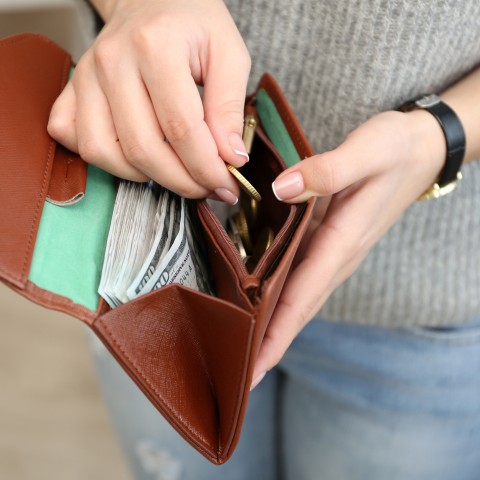 A Woman Getting Money from Her Wallet