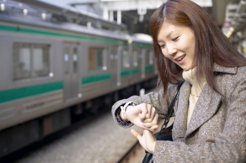 A Woman at a Train Station Looking at Her Wristwatch