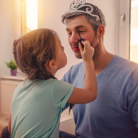 Daughter Putting Make-up on Her Daddy